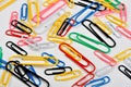 coloured paper clips and a white background Royalty Free Stock Photo