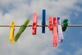 Coloured pegs on a washing line with sky Royalty Free Stock Photo