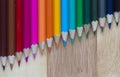 Coloured pencils against a wooden background Royalty Free Stock Photo