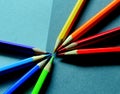 Coloured pencils radiant composed on a grey paper background Royalty Free Stock Photo