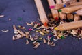 Coloured pencils and shavings against a black background Royalty Free Stock Photo