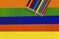 Coloured Pencils on a Striped Background Royalty Free Stock Photo
