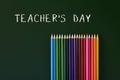 Coloured pencils and text teachers day written in a green chalkb Royalty Free Stock Photo