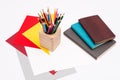 Coloured pencils in the wooden pencil box and a stack of daily planners Royalty Free Stock Photo