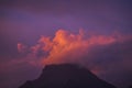 Coloured purple violet sunset at the muntain with white clouds above - beautiful mounts landscape with amazing colors - concept of