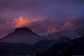 Coloured purple violet sunset at the muntain with white clouds above - beautiful mounts landscape with amazing colors - concept of