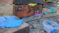 Coloured putty layered between building bricks