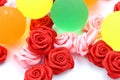 Coloured rubber ball with rose like object on white background