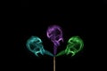 Coloured smoke coming out of incense sticks. Abstract smoke art