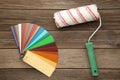 Coloured swatches and paint roller on grey table Royalty Free Stock Photo