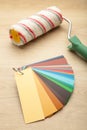 Coloured swatches and paint roller on table Royalty Free Stock Photo