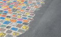 coloured tiles on a pavement in a downfacing perspective