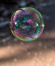 Coloured translucent soap bubble floating in the air Royalty Free Stock Photo