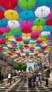 Coloured umbrellas suspended above shopping street