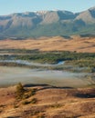 Coloured valley and bend of river with morning fog