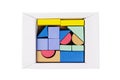 Coloured wooden figures in box on white background. Childrens building blocks. Geometric shapes. The concept of logical thinking