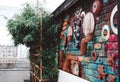 Colourful backdrop with many art crafts hanging on the wall with bamboo shrubs.