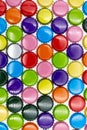 Colourful background made of different crown corks or caps like red, blue, gold, orange lined up in vertical format Royalty Free Stock Photo