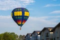 Colourful of balloon on blue sky with home village