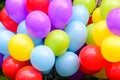 Colourful balloons at a children playground, in direct sunlight, blue, yellow, red and mauve mixed balloons Royalty Free Stock Photo