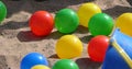 Colourful balls buckets and spades in childs sand pit Royalty Free Stock Photo