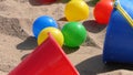 Colourful balls buckets and spades in childs sand pit Royalty Free Stock Photo