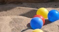 Colourful balls buckets and spades in childs sand pit Royalty Free Stock Photo