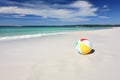 Colourful beach ball on the seashore by the ocean Royalty Free Stock Photo