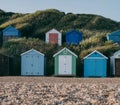 Colourful beach huts on a pebble beach in Milford on Sea, UK Royalty Free Stock Photo