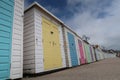 Colourful beach huts beside the sea.