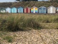 Colourful beach-huts in Suffolk on a sunny day