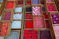 Colourful beads in different sizes and shapes sold in wooden compartment Royalty Free Stock Photo