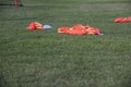 Colourful bibs left on a football pitch, ready for the next training session to come.