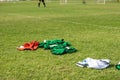 Colourful bibs left on a football pitch.