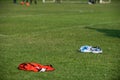 Colourful bibs left on a football pitch.