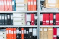 Colourful blank blind folders with files in the shelf. Archival, stacks of documents at the office or library. Physical document Royalty Free Stock Photo