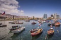 Colourful botes anchored at AntofagastaÃÂ´s Harbour and the chilean flag in the left. Antofagasta City at the background. Royalty Free Stock Photo