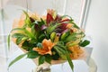 Colourful bouquet of lilies in orange scale.