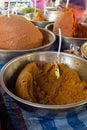 Colourful bowls of freshly made curry paste for sale at Thai food market
