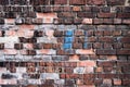 Colourful brick wall texture background. Old weathered and cracked red, orange, brown and grey bricks Royalty Free Stock Photo