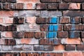 Colourful brick wall texture background. Old weathered and cracked red, orange, brown and grey bricks Royalty Free Stock Photo