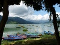 Colourful rowing boats on Phewa Lake, Pokhara, Nepal with mountains Royalty Free Stock Photo