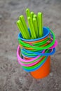 Colourful buckets on a sandy beach