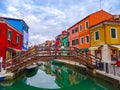 The amazing colourful buildings of Burano with a bridge over the canal in Italy