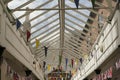 Colourful bunting flags in a glass rooved walkway