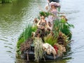 Colourful canal parade of flower and vegetables decorated boats with cheerful dressed up singing and dancing people