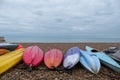 Colourful canoes on pebbly beach at Hove, East Sussex, UK. Photographed on a cold, calm winter`s day.