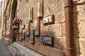 colourful ceramic images and jugs on outside wall in old Italian town of Gubbio