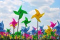 Colourful children`s pinwheels in the blue sky