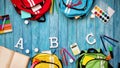 Colourful children schoolbags on wooden floor